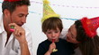 Parents playing with their son on his birthday