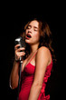 Beautiful singer singing with microphone