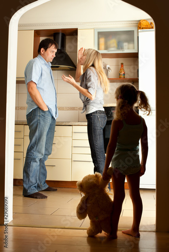 Photo: Child looks at the swearing parents Child looks at the swearing parents