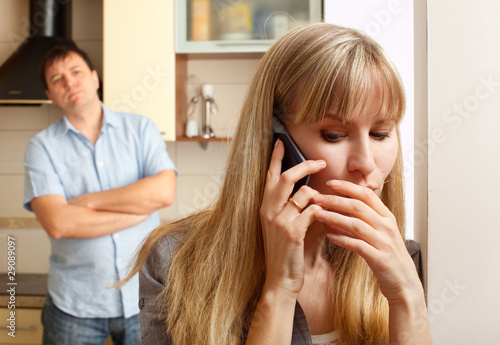 Photo: Wife confer privately on the phone Wife confer privately on the phone
