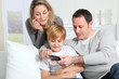 Photo: Family playing video game on smartphone Family playing video game on smartphone