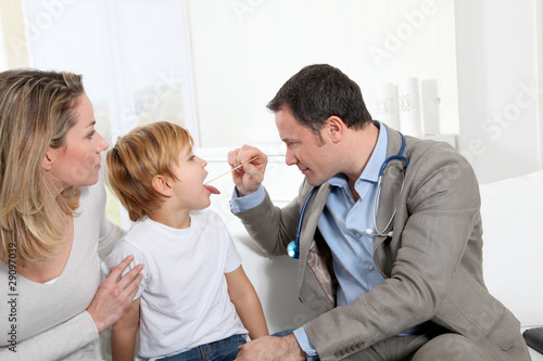 Photo: Doctor examining little boy throat Doctor examining little boy throat