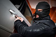 robber and the thief in a mask hijacks the car