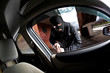 robber and the thief in a mask hijacks the car