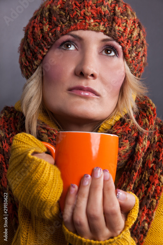 Photo: Beauty, blondie woman with an orange-colored cup Beauty, blondie woman with an orange-colored cup
