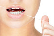 Young caucasian woman flossing her teeth , isolated on white Young caucasian woman flossing her teeth , isolated on white