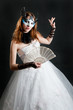 Photo: Girl with fan and mask in white dress Girl with fan and mask in white dress