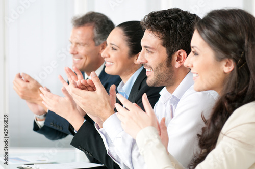 Photo: Business team clapping hands Business team clapping hands