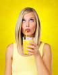 Foto: Thoughtful woman sipping orange juice Thoughtful woman sipping orange juice