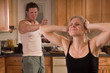 Photo: battered wife covers ears as husband yells at her battered wife covers ears as husband yells at her