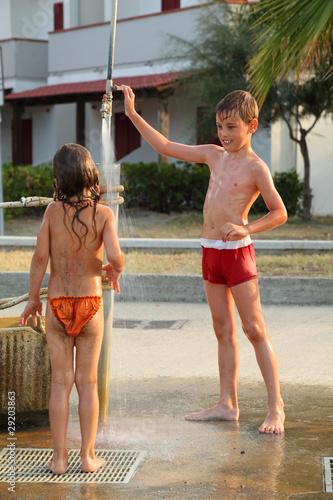 Photo: brother and sister are taking outdoor shower after swim brother and sister are taking outdoor shower after swim