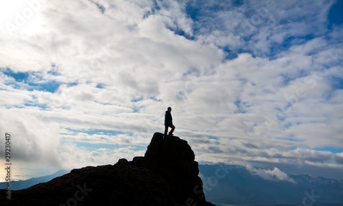 Photo: Silhouette of woman on the top of the rock Silhouette of woman on the top of the rock