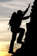 silhouette of a traveler tourist mountaineer on sunrise
