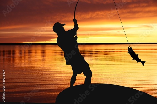 Illustration: Fisherman with fishing tackle and catching fish at sunrise Fisherman with fishing tackle and catching fish at sunrise