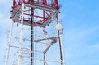 Telecommunication tower agains blue sky background
