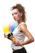 Young woman with a color guide and paintbrushes. Young woman with a color guide and paintbrushes.