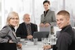 Mid-adult businesspeople sitting at meeting