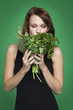 Young woman holding fresh herbs