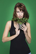 Young woman holding pot of ivy