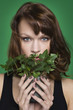 Young woman holding pot of ivy