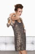 Young woman in formalwear holding shoes