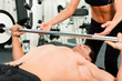 man in gym exercising with barbell