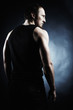 The muscular male back on black background