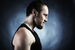 Strong athletic man on black background. Shooting in studio