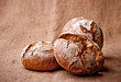 Homemade whole & break dark bread on sacking background