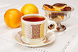 tea drinking with  slices of orange coated chocolate