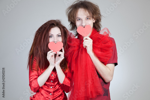 Photo: Girl and boy holding paper hearts Girl and boy holding paper hearts