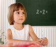 Elementary school pupil writing in a classroom