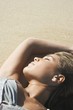 Young Woman Sunbathing on Beach