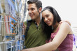 Young couple looking at postcards, portrait