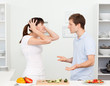 Photo: Young lovers having dispute in the kitchen Young lovers having dispute in the kitchen
