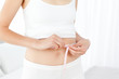 Woman looking at  her waistline