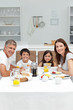 Photo: Family having breakfast in the kitchen Family having breakfast in the kitchen