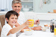 Father having his breakfast with his son Father having his breakfast with his son