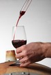 Sampling the wine from an oak barrel
