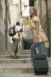 Woman with Luggage in Alley
