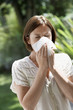Foto: Woman Blowing Nose in garden Woman Blowing Nose in garden
