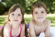 Boy and girl lying in backyard, portrait, close up