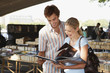 Young couple looking at book in inner-city book market