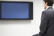 Businessman Looking at Flat Panel Television