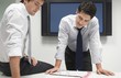 Two Businessmen Looking in File Folder