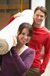 Photo: Couple Carrying Rolled Carpet Couple Carrying Rolled Carpet