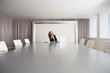Female Business Executive Sitting in Boardroom using Laptop