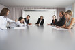 Businesswoman Waking Sleeping Colleague During Meeting