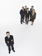 Businessman standing apart from group