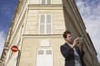 Photo: Paris, France, Man studying guide book in front of apartment block Paris, France, Man studying guide book in front of apartment block